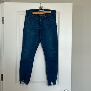 Ann Taylor Loft size 28 skinny jeans with distressed hems.
